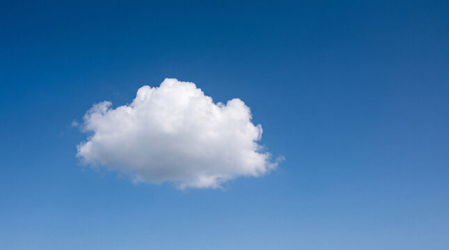 A beautiful photograph of a single white fluffy cumulus cloud floating peacefully in a clear blue sky.