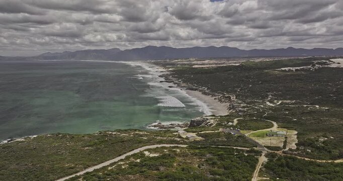 Gansbaai South Africa Aerial v13 flyover above Walker Bay Nature Reserve entrance, beach and Klipgat Caves beneath coastal mountains - Shot with Mavic 3 Pro Cine - Jan 8th 2024