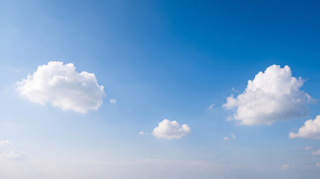 Vibrant blue sky dotted with scattered fluffy white cumulus clouds, creating a bright and airy atmospheric backdrop.