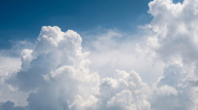 Dramatic, billowy white and gray cumulus clouds against a dynamic blue sky, showcasing powerful atmospheric changes.