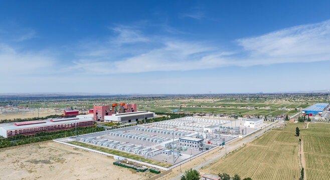 Aerial View of Battery Energy Storage Station near Industrial Factory Buildings