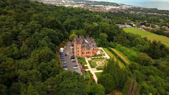 Anti-clockwise 4K 60FPS aerial video of Belfast Castle and Cavehill in North Belfast, Northern Ireland in the UK on a bright sunny day. Produced with Rec709 colour.
