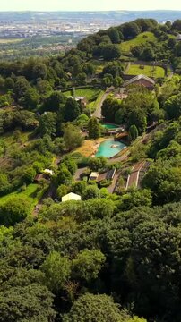 Anti-clockwise 60FPS vertical social ratio aerial video of Belfast Zoo and Cavehill in North Belfast, Northern Ireland in the UK on a bright sunny day. Produced with Rec709 colour.