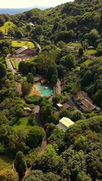 Clockwise 60FPS vertical social ratio aerial video of Belfast Zoo and Cavehill in North Belfast, Northern Ireland in the UK on a bright sunny day. Produced with Rec709 colour.