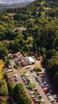 Passing 60FPS vertical social ratio aerial video of Belfast Zoo and Cavehill in North Belfast, Northern Ireland in the UK on a bright sunny day. Produced with Rec709 colour.