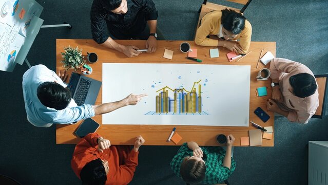 Team Collaboration on Business Growth Strategy with Analytics Charts and Coffee in Modern Office Environment. Entropy.