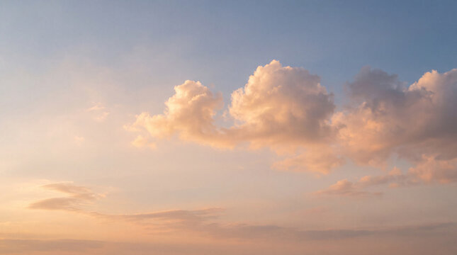 A picturesque photograph capturing fluffy cumulus clouds illuminated by the soft.