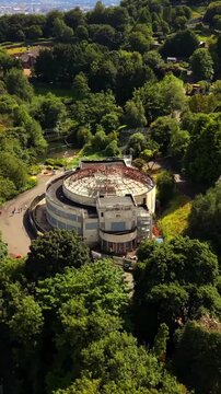 Descending 60FPS vertical social ratio aerial video of Belfast Zoo and Cavehill in North Belfast, Northern Ireland in the UK on a bright sunny day. Produced with Rec709 colour.