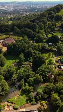 Reversing 60FPS vertical social ratio aerial video of Belfast Zoo and Cavehill in North Belfast, Northern Ireland in the UK on a bright sunny day. Produced with Rec709 colour.