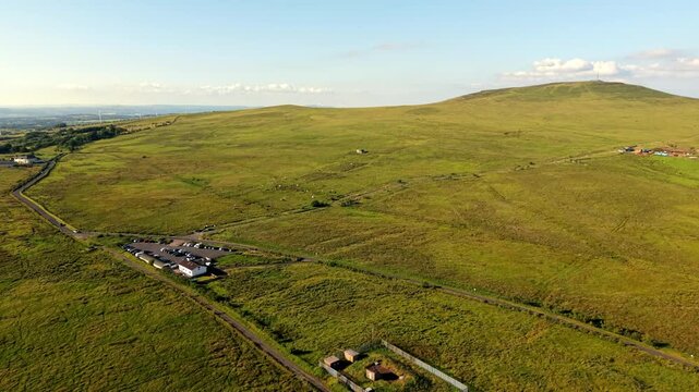 Rising 4K 60FPS aerial video of the Black mountain and Divis mountain in West Belfast, Northern Ireland in the UK on a bright sunny day. Produced with Rec709 colour.