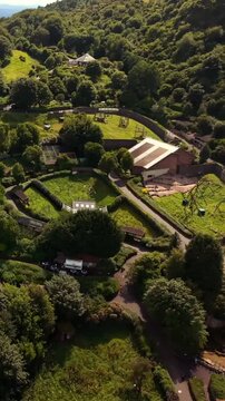 Passing 60FPS vertical social ratio aerial video of Belfast Zoo and Cavehill in North Belfast, Northern Ireland in the UK on a bright sunny day. Produced with Rec709 colour.