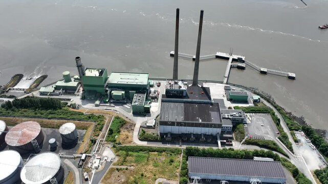 Drone downview. Drone footage capturing renewable energy power station on the River Suir, Wexford, Ireland. Detailed aerial views of electricity infrastructure