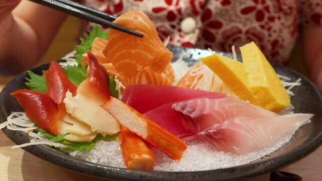 Mixed premium sashimi bowl including salmon, tuna, hamachi and tamago on ice