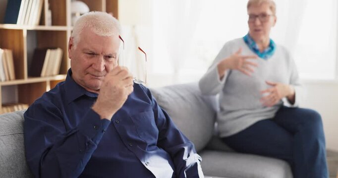 Senior couple in conflict, upset and stress. Older partners dispute at home, highlighting relationship strain and communication problems. Concept of aging relationship under stress today.