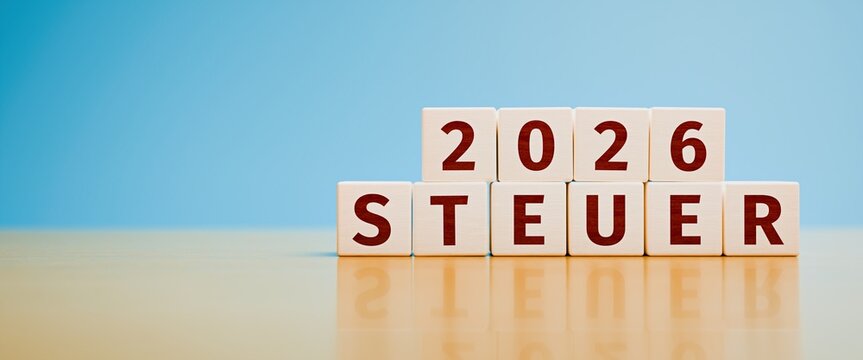Wooden toy cubes forming the German language text "2026 STEUER" (2026 TAX). Concept for taxes for the year 2026.