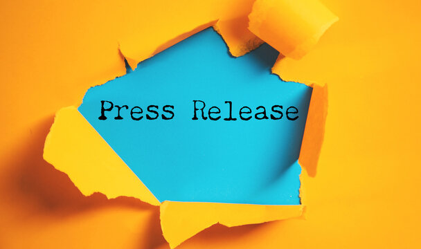press release word under torn  paper
