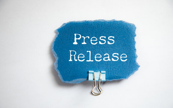 press release word under torn  paper