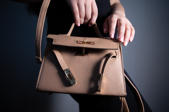 woman hand wallet with bag on dark background