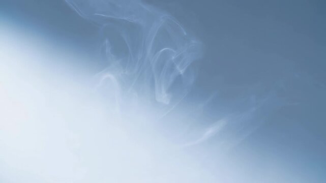 Soft blue abstract sky with pale white smoke curls drifting upward through airy space, bright lower-left glow, minimal calm composition for freshness, serenity, modern background use
