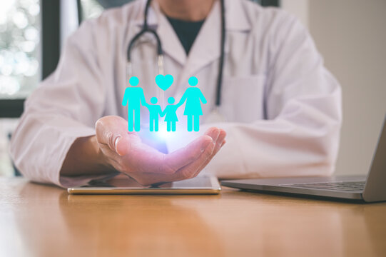 Medical health Insurance and wellness concept, Doctor holding family icon at hospital office. Medical health care and doctor staff service.