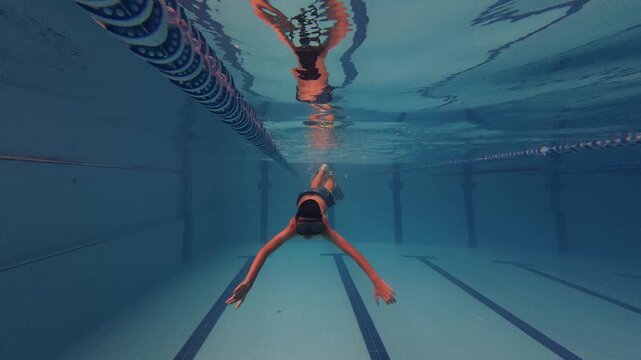 Boy Swimming Underwater with Mask in Swimming Pool