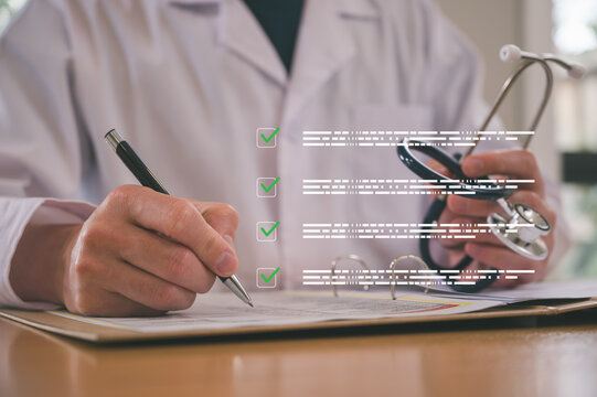 Male doctor wearing white cloth and stethoscope using pen and paper report analysing patient diagnosis data in medicine and healthcare concept