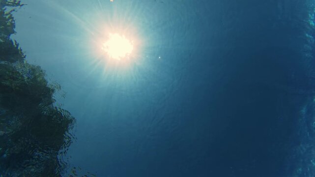 Underwater Low Angle View of Sun Rays Shining Through Blue Water