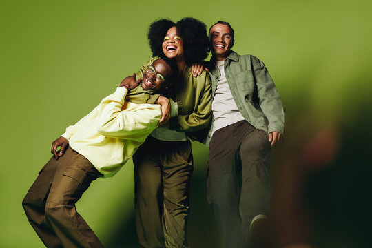 Young friends having fun in a cheerful studio portrait with happy chemistry