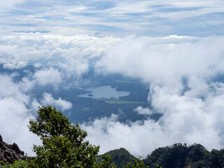 Fototapeta premium Mountain Lake Revealed Through Drifting Clouds from a High Alpine Viewpoint