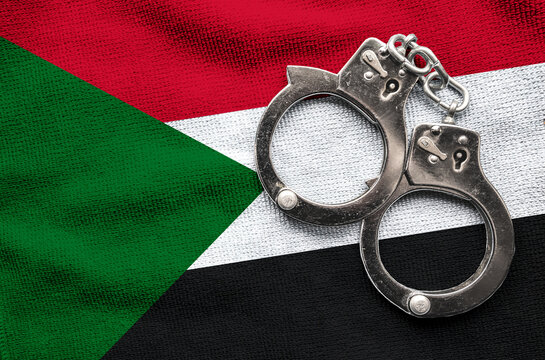 Flag of Flag of Sudan and police handcuffs. Crime and offenses in country Concept
