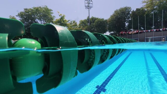 Split View Close Up of Green Lane Divider in Outdoor Swimming Pool