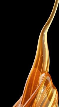 Golden honey flows down in a glossy stream, showing its thick texture and rich color against a dark background.