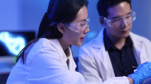 Close-up video of scientists conducting experiments in a laboratory.