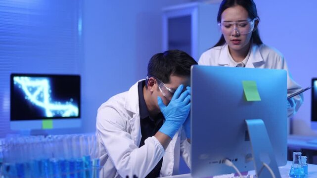 A young scientist looks stressed in the laboratory.