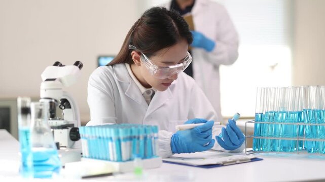 An Asian female scientist works with samples in a science laboratory.