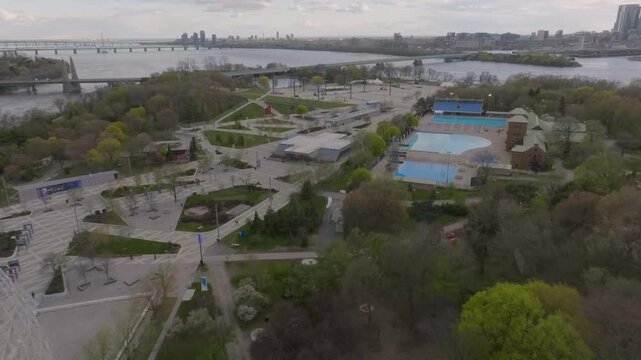 drone flying from biosphere towars metro n pool in park jean drapeau in montreal quebec canada