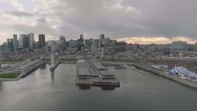drone over turning almost 360 showing circle du Soleil old port of montreal river boats habitat 67 river n main bridge going towards park jean drapeau