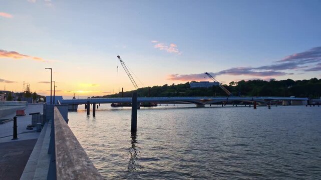 timelapse on the Suir River at Sunset from Waterford Quays glowing sky flowing river on a summer evening