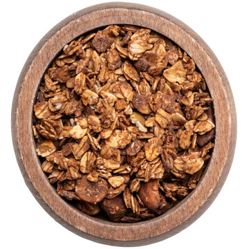 Top view of crunchy granola in wooden bowl isolated on transparent background