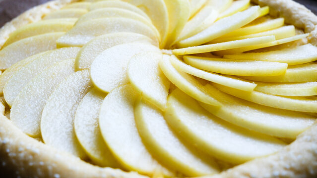 A delightful apple dessert. Raw apple pie with apples, in the process of being prepared.