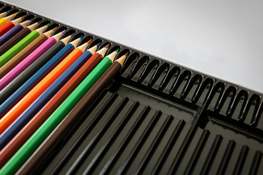 Colorful Pencils Arranged in a Partially Empty Black Case