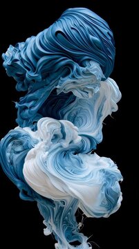 Watch as paint billows like clouds in water, creating dynamic shapes and patterns in deep blue and white shades.