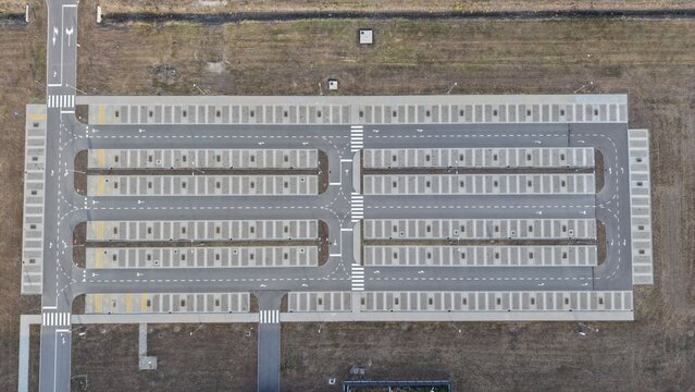 Aerial view of the Severna Zona parking lot with clearly marked parking spaces, asphalt lanes, and pedestrian crossings in Pancevo, Serbia.