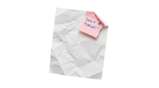 Pink sticky note with text dont forget attached to crumpled white paper.
