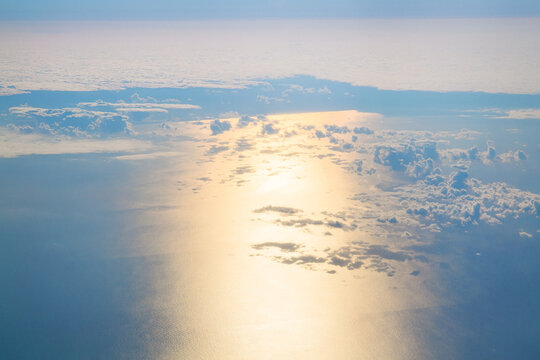 Aerial Sun Reflection On Ocean Through Clouds