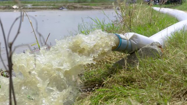 Water discharging from white drainage hose
