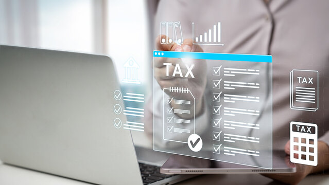 A businesswoman filing taxes online using a laptop and tablet with virtual checklist and financial icons. Concept of house and property tax