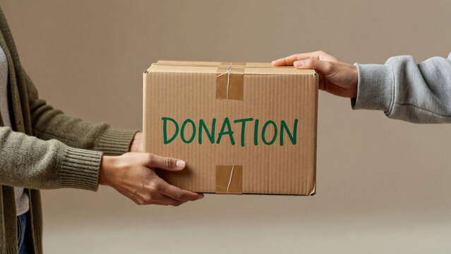 People's hands passing cardboard donation box with "DONATION" text, charitable giving and community support