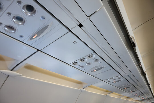 Close-up of the warning and signal controls, located above the seats, inside a passenger aircraft.