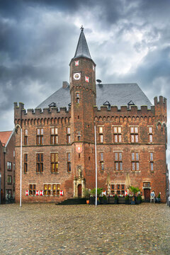 Brick facade of historic town hall in Kalkar, Germany. Rainy daylight under a cloudy grey sky